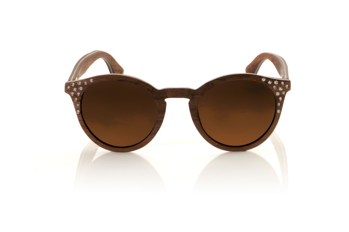 Wood eyewear of Walnut LANA. LANA wooden sunglasses, from our collection of organic glasses, entirely made of laminated walnut wood. This model perfectly combines natural elegance with an iconic design: a rounded shape with a straight eyebrow, creating a visual balance that enhances any type of face. But what really sets LANA apart are the sparkling Czech crystals embedded at the ends of the brows, adding a touch of light and sophistication. Ideal for those looking to stand out with a unique accessory, LANA is not just a pair of glasses, but a statement of style and ecological awareness. Measurements 147x50mm Caliber 47 for Wholesale & Retail | Root Sunglasses® 